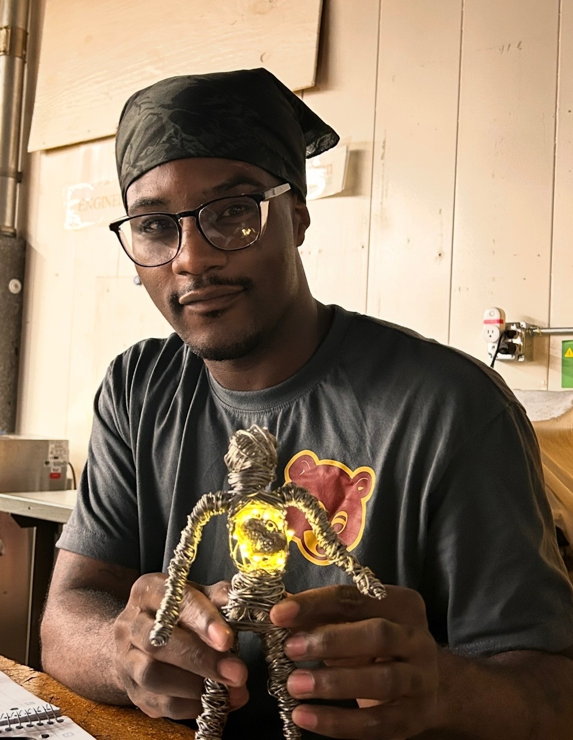 Residential wiring student Vernon Houston proudly displays his wire figurine